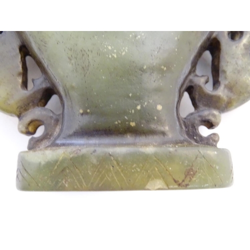 851 - An Oriental soapstone vase of baluster form with stylised figural and animal twin handles. Approx. 4... 