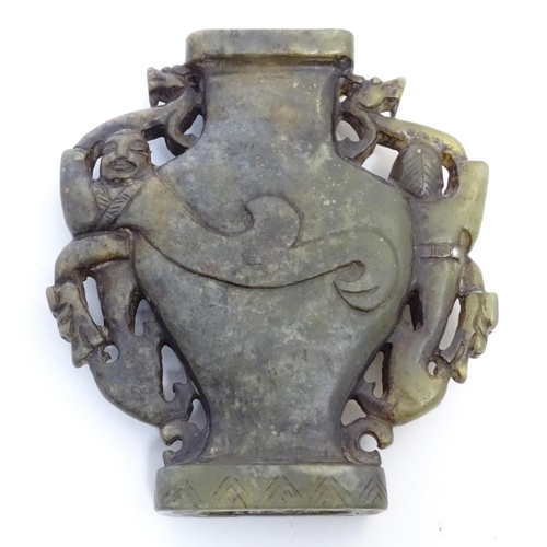 851 - An Oriental soapstone vase of baluster form with stylised figural and animal twin handles. Approx. 4... 