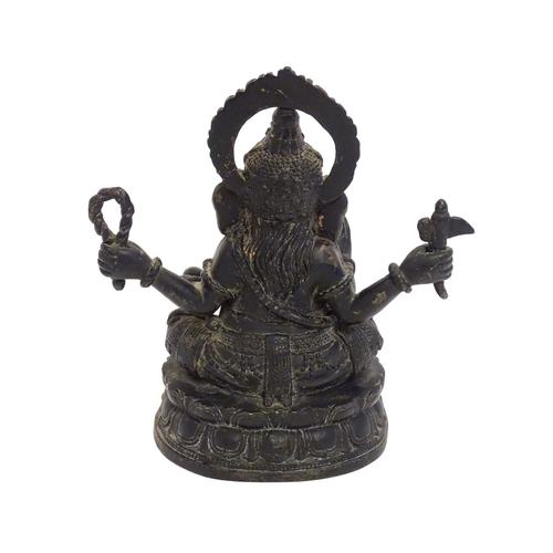 856 - A 19thC cast bronze model of the Hindu deity Ganesh with attributes including an open palm, an axe, ... 