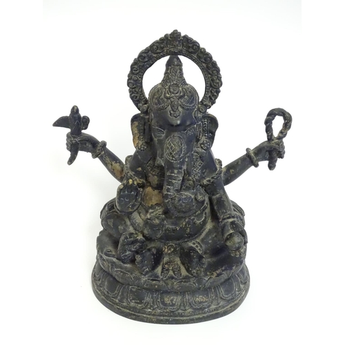 856 - A 19thC cast bronze model of the Hindu deity Ganesh with attributes including an open palm, an axe, ... 