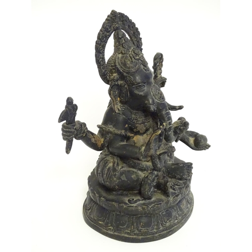 856 - A 19thC cast bronze model of the Hindu deity Ganesh with attributes including an open palm, an axe, ... 