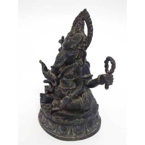 856 - A 19thC cast bronze model of the Hindu deity Ganesh with attributes including an open palm, an axe, ... 