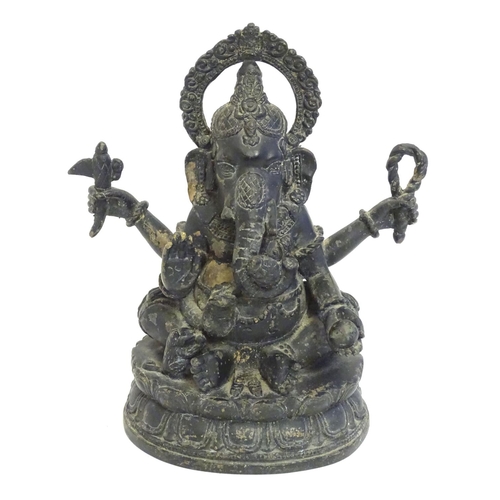 856 - A 19thC cast bronze model of the Hindu deity Ganesh with attributes including an open palm, an axe, ... 