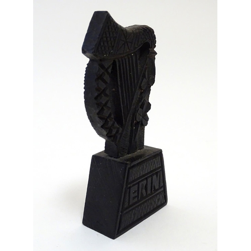 891 - A 19thC Irish bog oak carved harp with shamrock decoration on a tapering base inscribed Erin. Approx... 