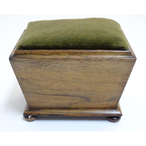 894 - A 19thC rosewood pin cushion of sarcophagus form with four bun feet. Approx. 4 1/4