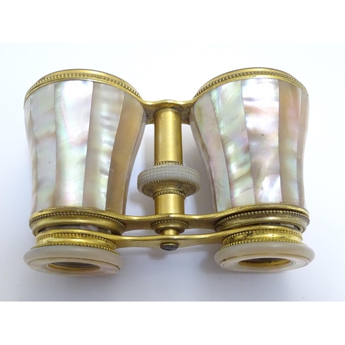 905 - A late 19th / early 20thC pair of gilt brass and mother of pearl opera / theatre glasses. Approx. 2 ... 