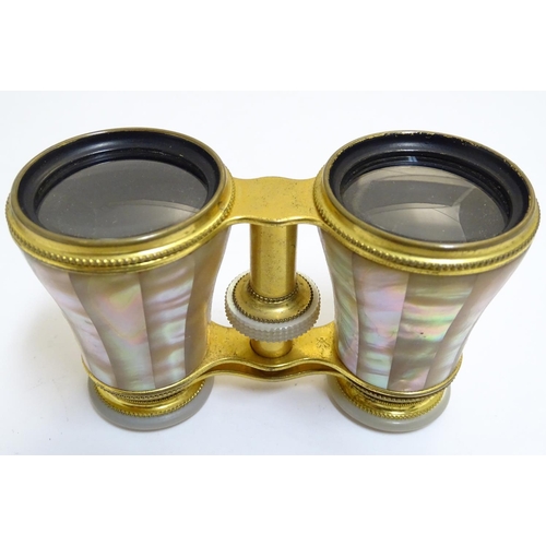 905 - A late 19th / early 20thC pair of gilt brass and mother of pearl opera / theatre glasses. Approx. 2 ... 