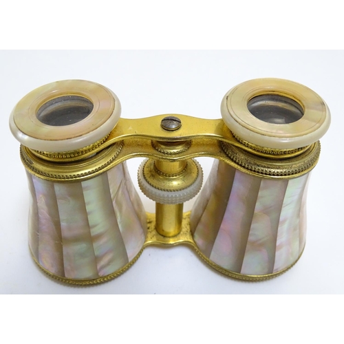 905 - A late 19th / early 20thC pair of gilt brass and mother of pearl opera / theatre glasses. Approx. 2 ... 