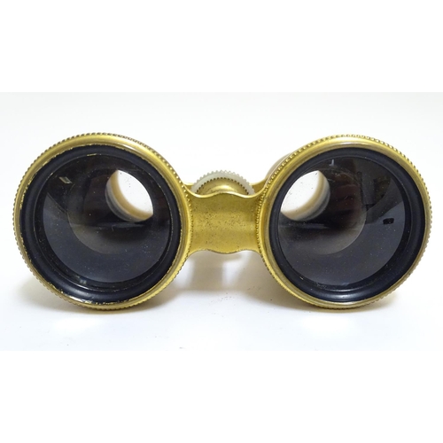 905 - A late 19th / early 20thC pair of gilt brass and mother of pearl opera / theatre glasses. Approx. 2 ... 