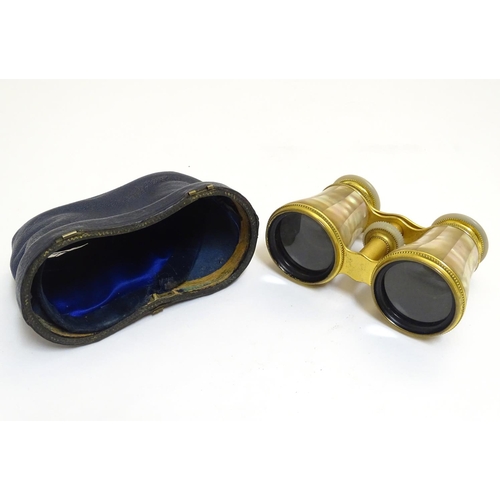 905 - A late 19th / early 20thC pair of gilt brass and mother of pearl opera / theatre glasses. Approx. 2 ... 