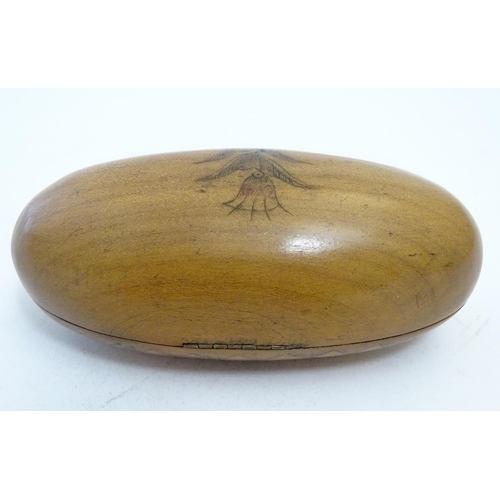 913 - A 19thC Scandinavian treen snuff box of oval form with naive penwork decoration depicting stylised f... 