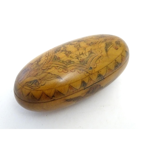 913 - A 19thC Scandinavian treen snuff box of oval form with naive penwork decoration depicting stylised f... 