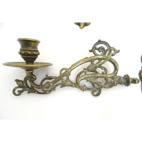 945 - A trio of 19thC brass adjustable double wall sconces, decorated with acanthus fronds and elements of... 