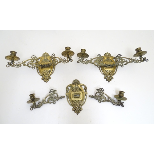 945 - A trio of 19thC brass adjustable double wall sconces, decorated with acanthus fronds and elements of... 