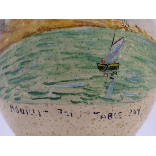 960 - A 20thC hand painted ostrich egg depicting Mouille Point, Table Bay, South Africa, a coastal scene w... 