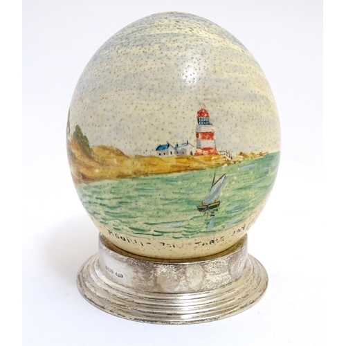 960 - A 20thC hand painted ostrich egg depicting Mouille Point, Table Bay, South Africa, a coastal scene w... 