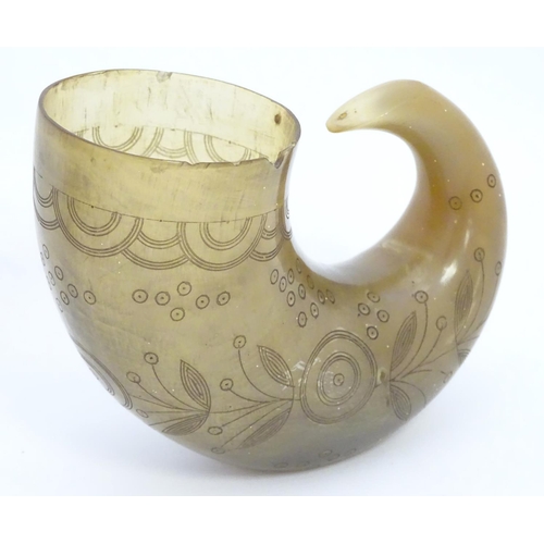 966 - A 19thC rams horn vessel / flask with engraved foliate and roundel decoration. Approx. 4 1/2