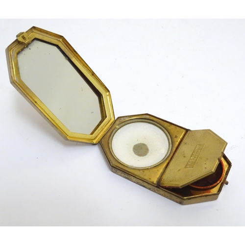 970 - A French Art Deco gilt compact vanity by Houbigant, France, opening to reveal a mirror and two compa... 