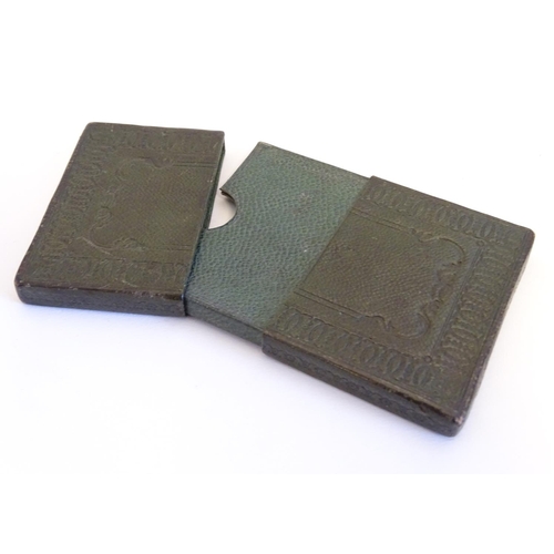 979 - A 20thC green leather card case with embossed decoration. Approx. 3 3/4