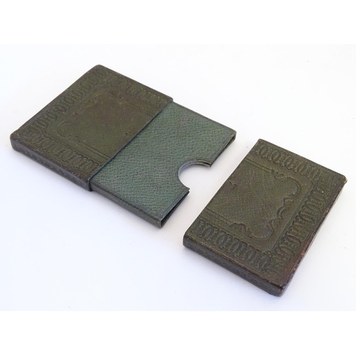 979 - A 20thC green leather card case with embossed decoration. Approx. 3 3/4