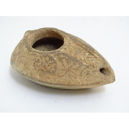 986 - A Roman style terracotta oil lamp with incised decoration. Approx. 1 1/2