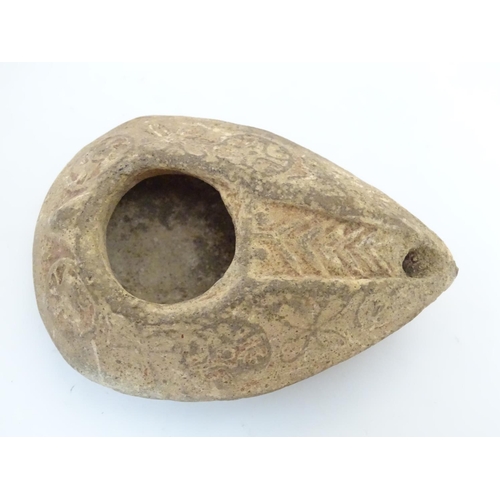 986 - A Roman style terracotta oil lamp with incised decoration. Approx. 1 1/2