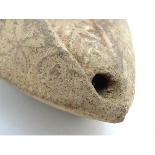 986 - A Roman style terracotta oil lamp with incised decoration. Approx. 1 1/2