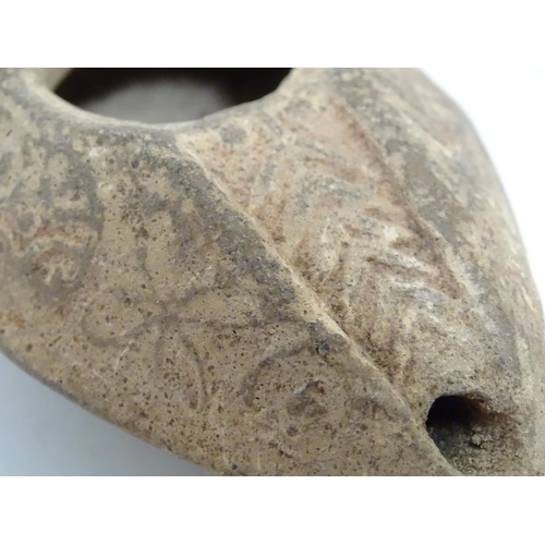 986 - A Roman style terracotta oil lamp with incised decoration. Approx. 1 1/2