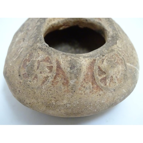 986 - A Roman style terracotta oil lamp with incised decoration. Approx. 1 1/2