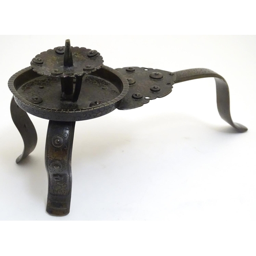 1001 - A Japanese bronze candle stand with a raised sconce, on three supports, with scrolling punchwork dec... 