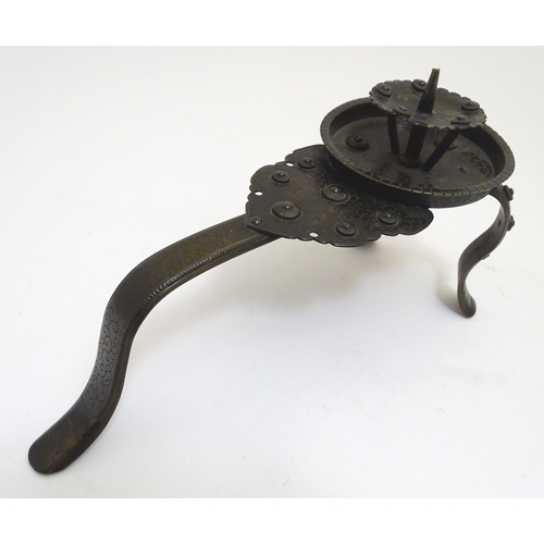 1001 - A Japanese bronze candle stand with a raised sconce, on three supports, with scrolling punchwork dec... 