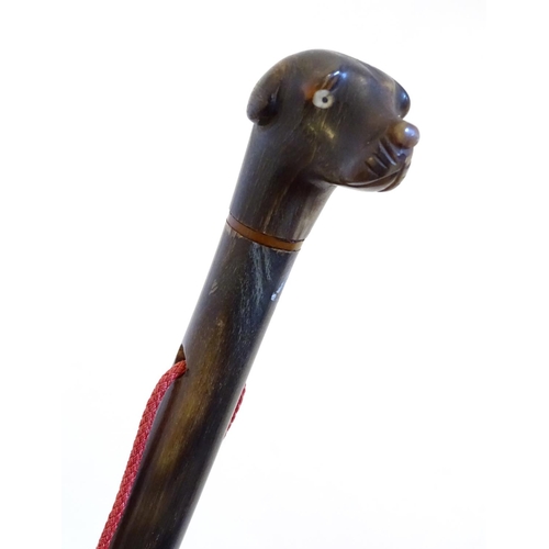 1104 - A 19thC carved horn handled fly swish, the knop carved as the head of a dog. Approx. 29