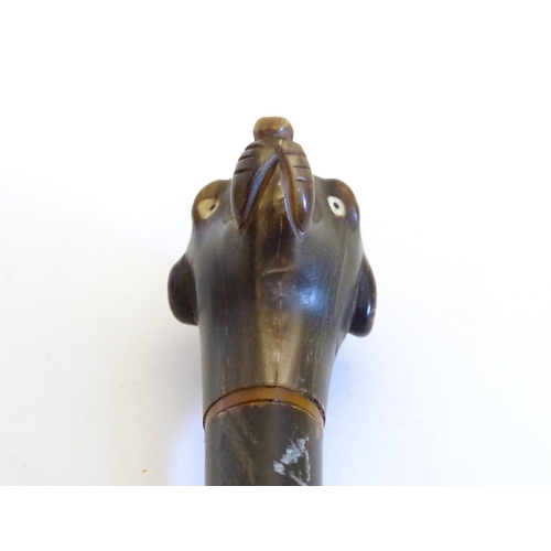 1104 - A 19thC carved horn handled fly swish, the knop carved as the head of a dog. Approx. 29