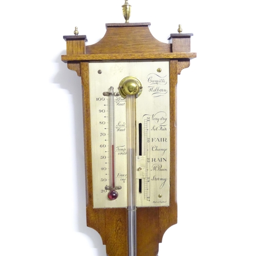 1187 - A mid 20thC stick barometer, the plate marked ' Comitti, Holborn', mahogany case with brass finials.... 