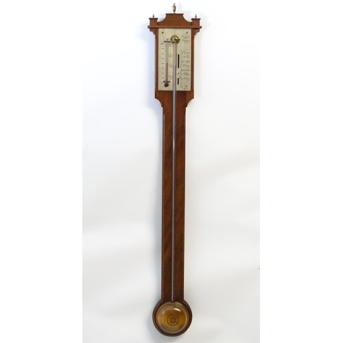 1187 - A mid 20thC stick barometer, the plate marked ' Comitti, Holborn', mahogany case with brass finials.... 