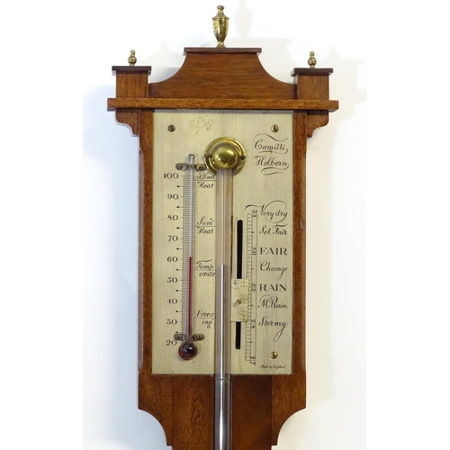 1187 - A mid 20thC stick barometer, the plate marked ' Comitti, Holborn', mahogany case with brass finials.... 