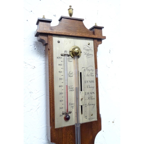 1187 - A mid 20thC stick barometer, the plate marked ' Comitti, Holborn', mahogany case with brass finials.... 