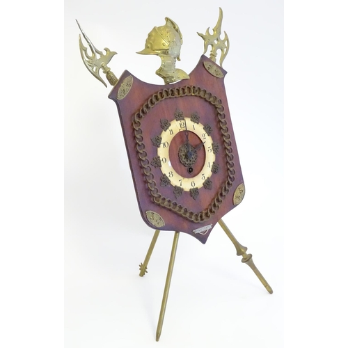 1189 - A late Victorian strut mantle clock, the brass stand formed as crossed halberd and helm, surmounted ... 