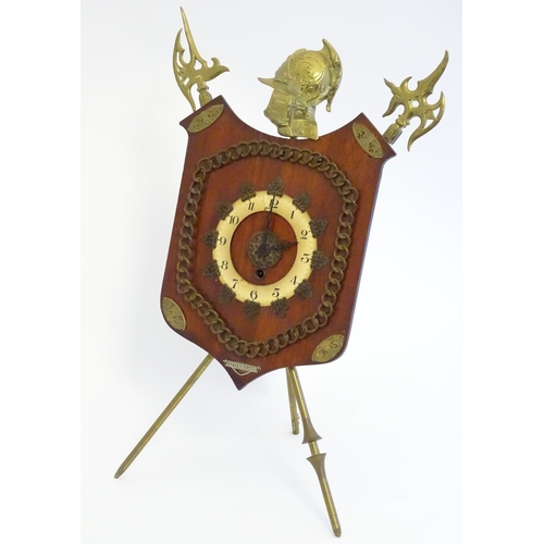 1189 - A late Victorian strut mantle clock, the brass stand formed as crossed halberd and helm, surmounted ... 