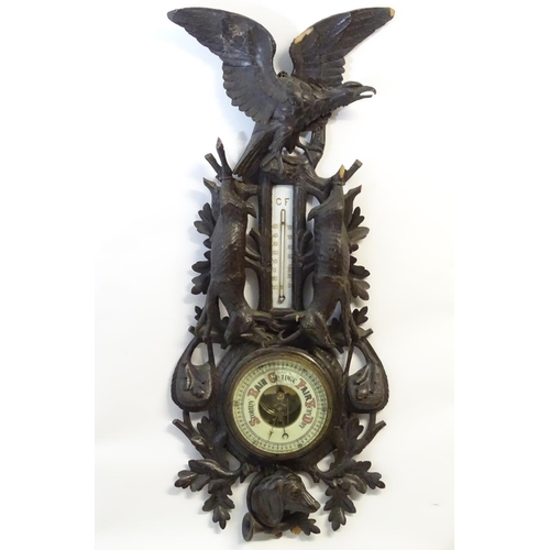 1194 - A late 19thC Black Forest barometer, the carved wooden case decorated with eagle, hanging game (roeb... 