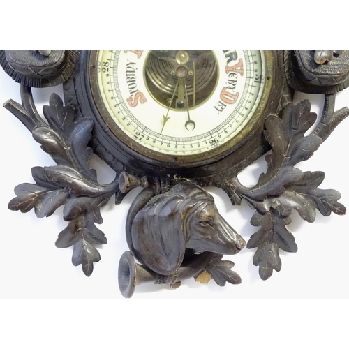 1194 - A late 19thC Black Forest barometer, the carved wooden case decorated with eagle, hanging game (roeb... 