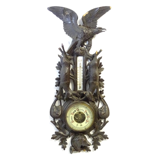 1194 - A late 19thC Black Forest barometer, the carved wooden case decorated with eagle, hanging game (roeb... 