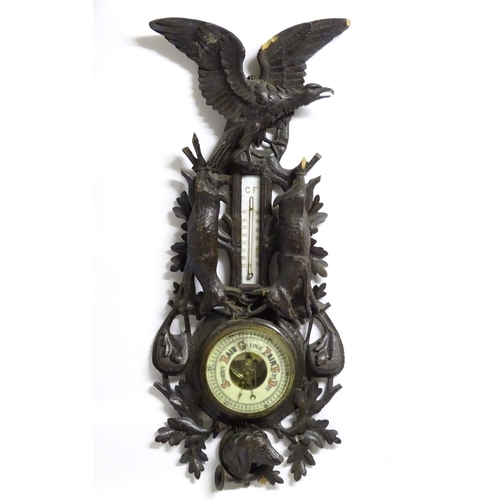 1194 - A late 19thC Black Forest barometer, the carved wooden case decorated with eagle, hanging game (roeb... 