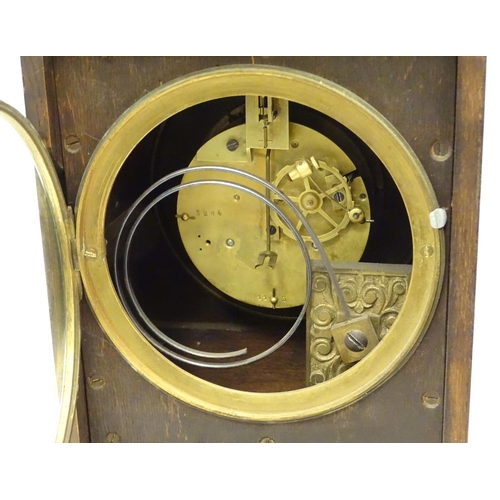 1197A - An Edwardian wall clock, the stained oak case housing a black and gilt numeral dial, 17 3/4