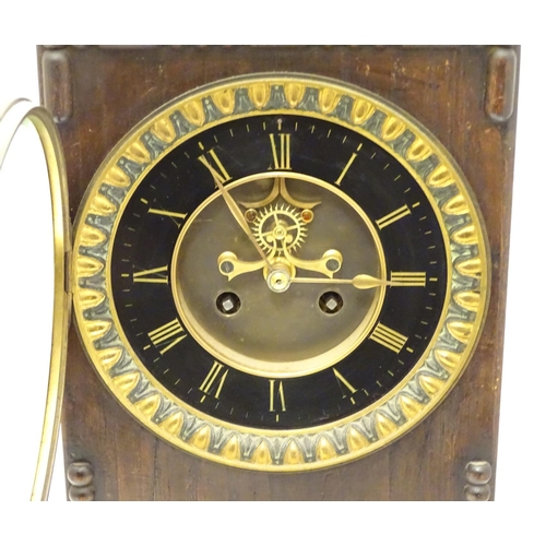 1197A - An Edwardian wall clock, the stained oak case housing a black and gilt numeral dial, 17 3/4