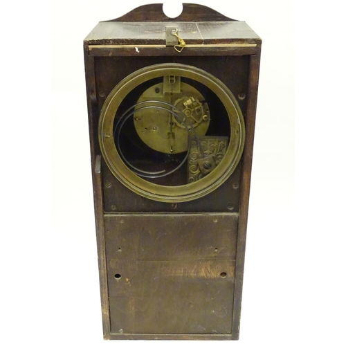 1197A - An Edwardian wall clock, the stained oak case housing a black and gilt numeral dial, 17 3/4