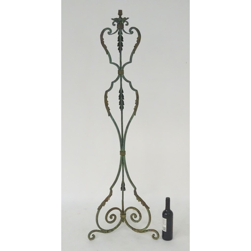 1220 - A late 19th / early 20thC wrought iron standard lamp with a verdigris finish and gilt foliate decora... 