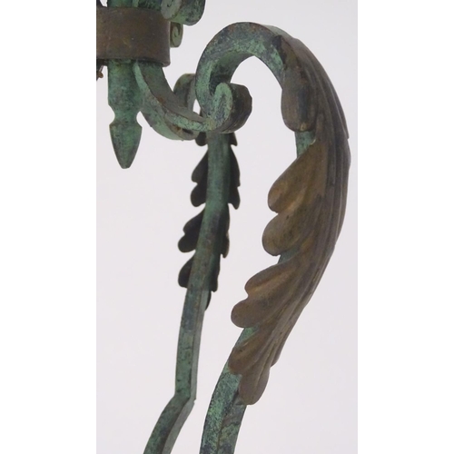 1220 - A late 19th / early 20thC wrought iron standard lamp with a verdigris finish and gilt foliate decora... 