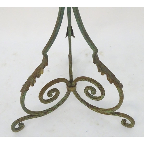 1220 - A late 19th / early 20thC wrought iron standard lamp with a verdigris finish and gilt foliate decora... 