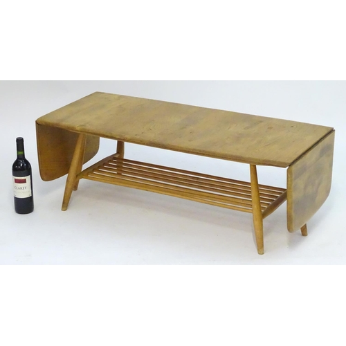 1234 - Vintage Retro, Mid-Century: an Ercol elm and beech coffee table, extending with drop flaps, standing... 